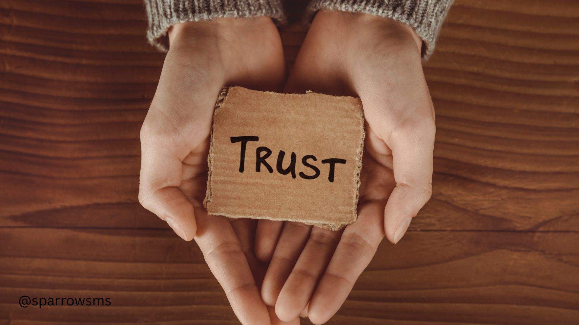 a person holding a sign trust